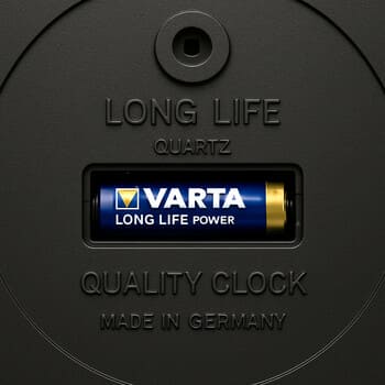 Backplate of a wall clock with accessible battery compartment and clear label